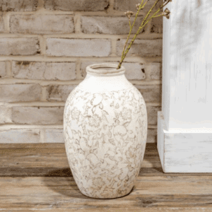 Elegant white vase with intricate floral patterns on a wooden surface.